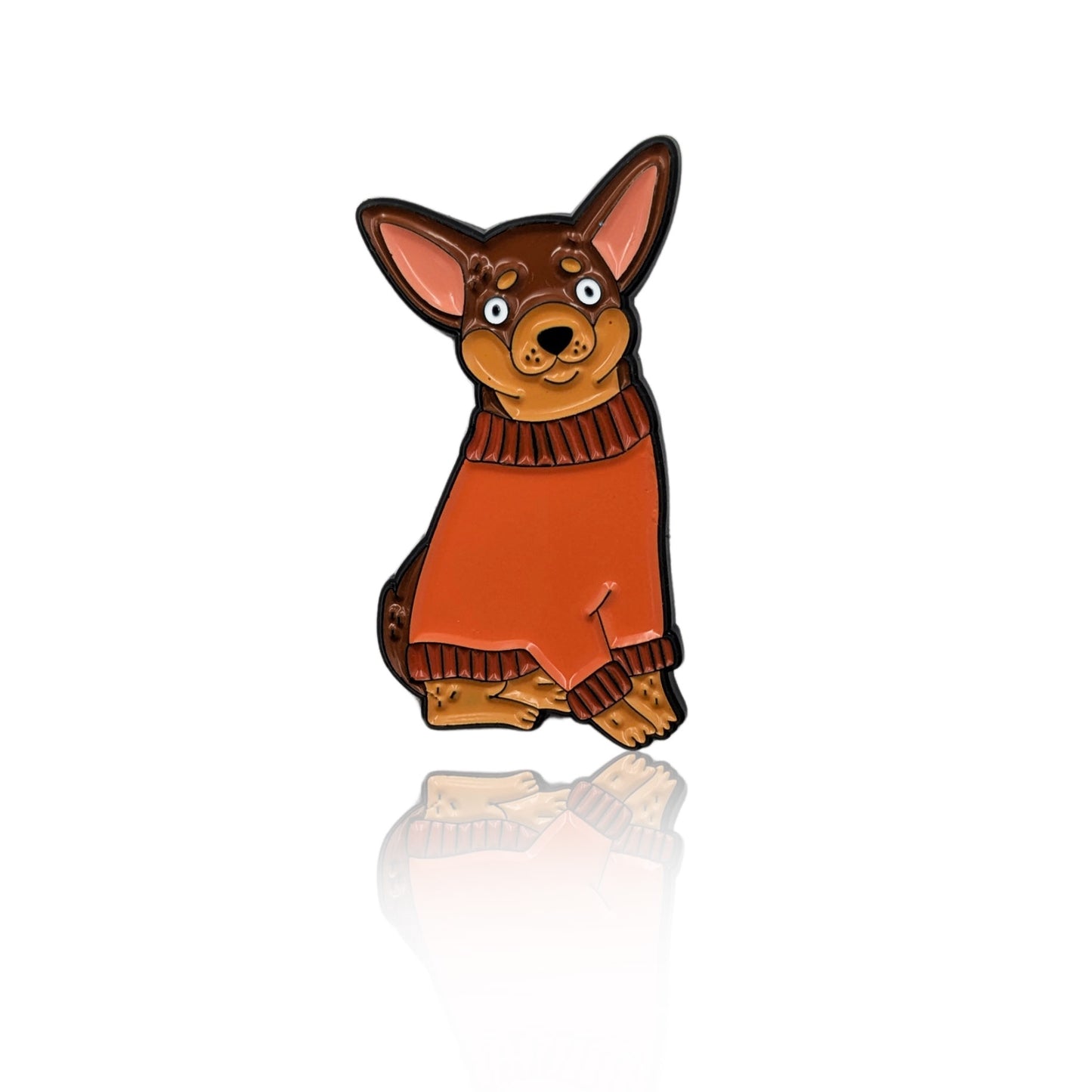 Enamel pin of a cartoon Chihuahua in a rust-colored sweater