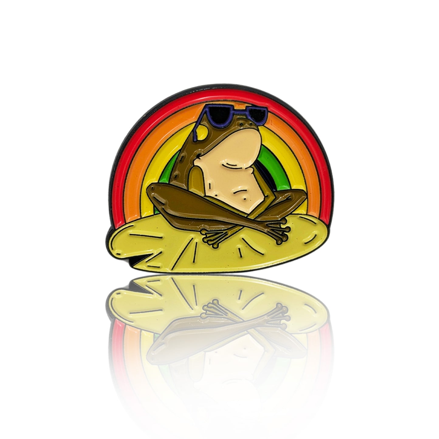 Enamel pin of a frog wearing sunglasses, sitting on a lily pad with a rainbow in the background