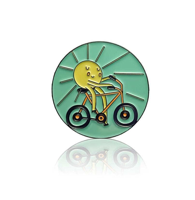 Sun on a bike enamel pin