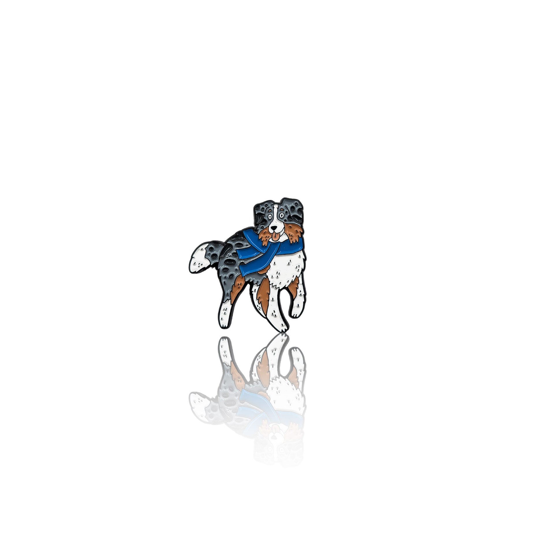 Enamel pin featuring an Australian Shepherd wearing a blue scarf, standing happily. The pin has a glossy finish with a reflection on a white background, making it a perfect winter-themed accessory for dog lovers.