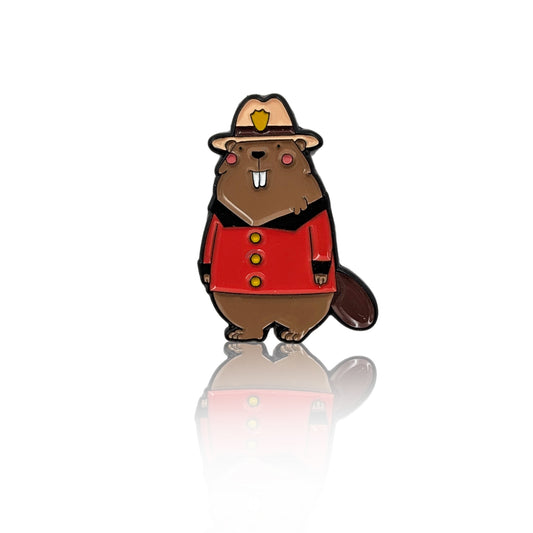 Cute beaver enamel pin wearing a Canadian Mountie uniform with red jacket and hat, shown on a white background