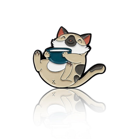 Cute cozy cat enamel pin holding a mug, curled up and smiling, shown on a white background