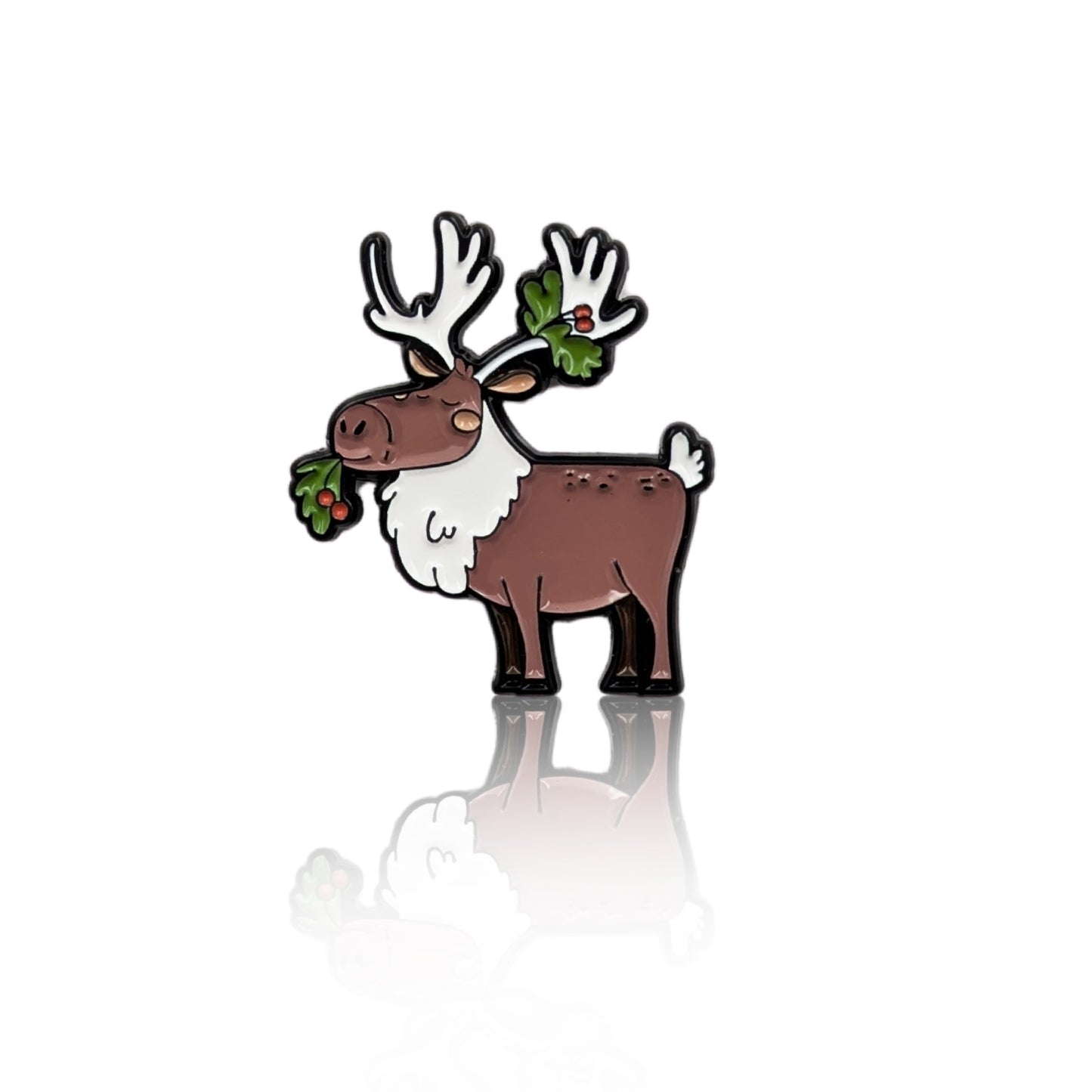 Cute caribou enamel pin with antlers and festive greenery, inspired by Canadian wildlife, shown on a white background