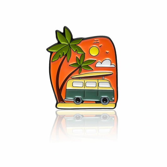 Green camper van enamel pin with surfboard, palm trees, and orange sunset background, 32mm by PINBOX