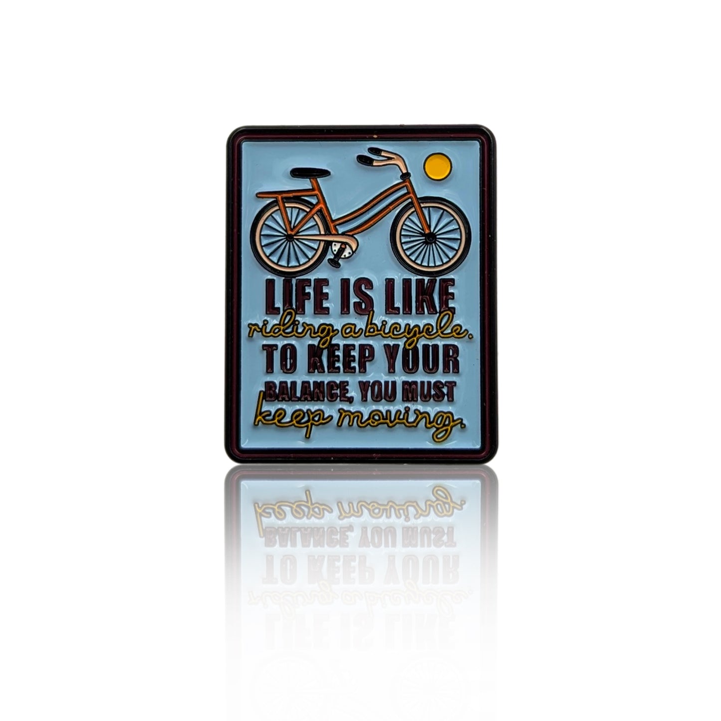 Bicycle quote enamel pin reading “Life is like riding a bicycle, to keep your balance you must keep moving,” shown on a white background