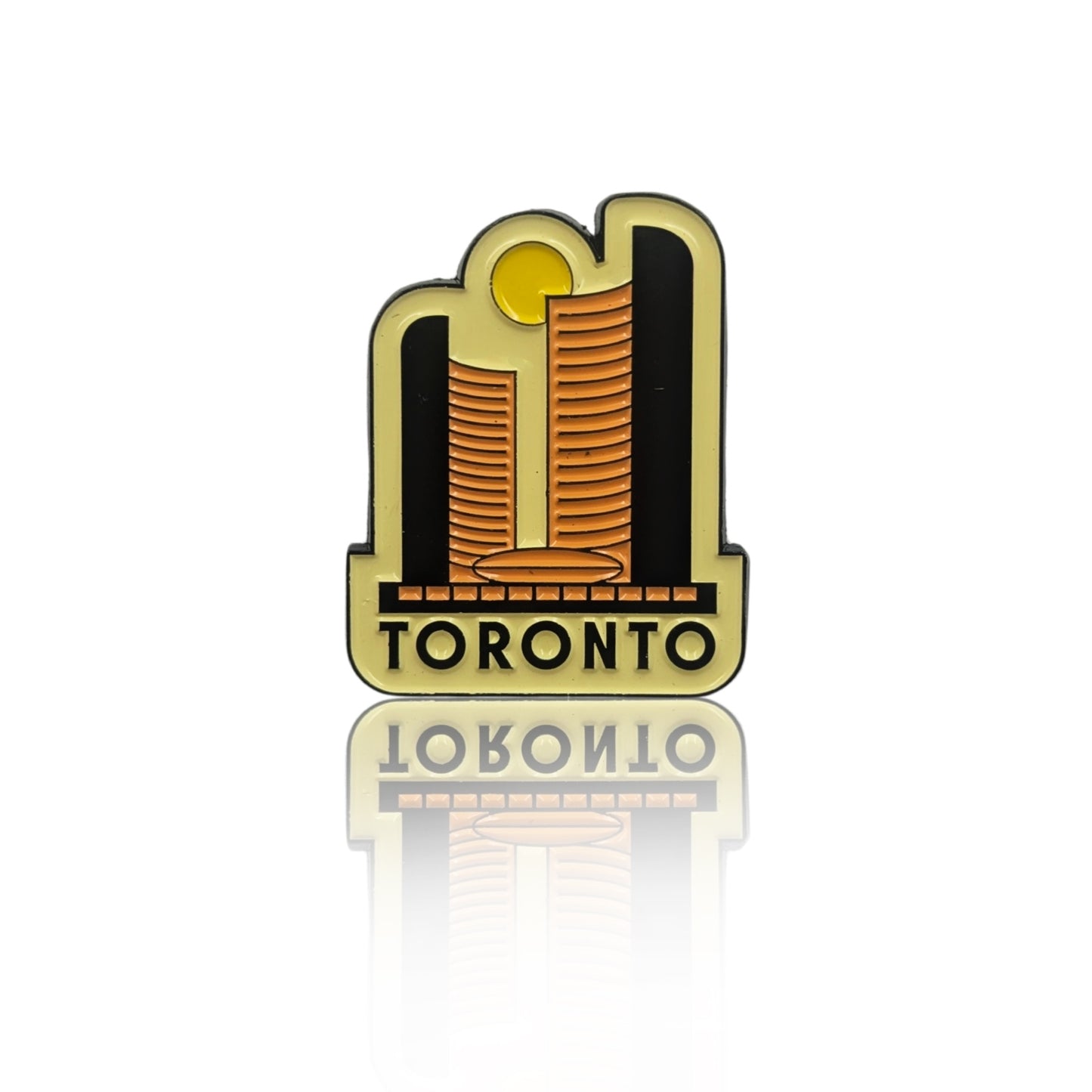 Toronto skyline enamel pin with two stylized golden towers and sun motif, shown on a clean white background