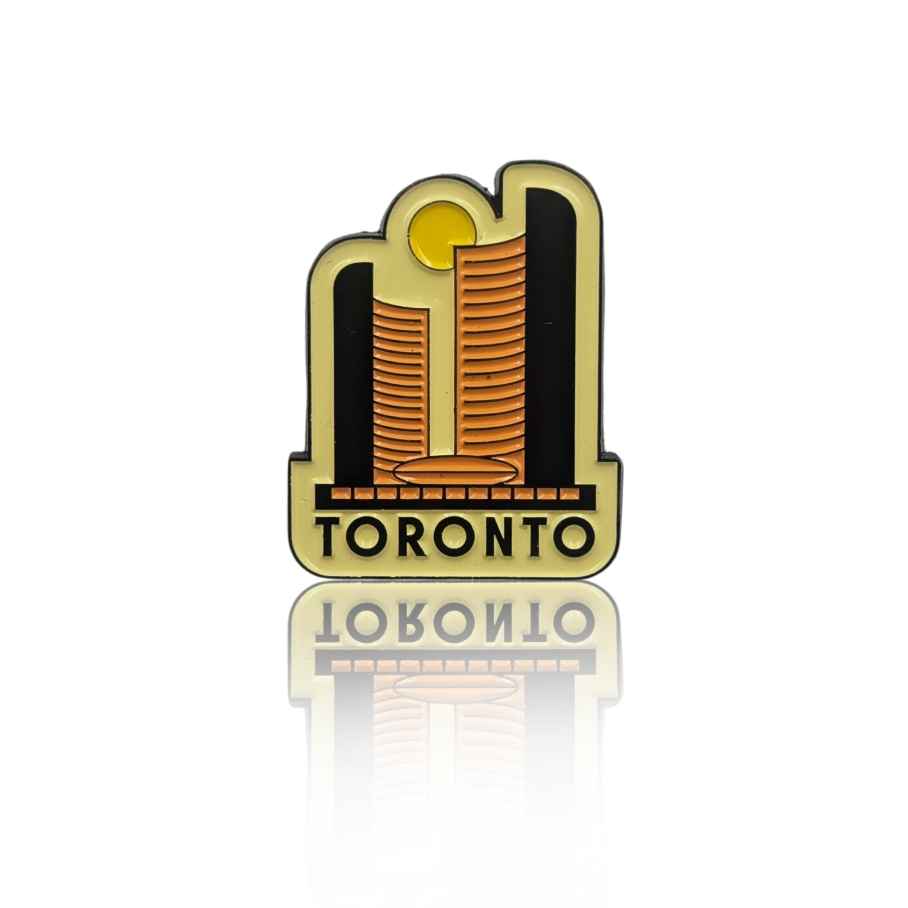 Toronto skyline enamel pin with two stylized golden towers and sun motif, shown on a clean white background